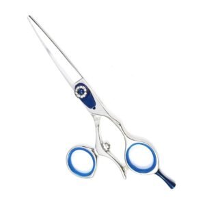 Professional stainless steel hair cutting shears featuring a high-polish metallic finish, a decorative blue adjustment screw dial studded with rhinestones, removable blue rubber finger inserts inside the handle rings, an integrated finger rest, and a bumper silencer, shown in Beauty-Instruments.jpg against a clean white background.